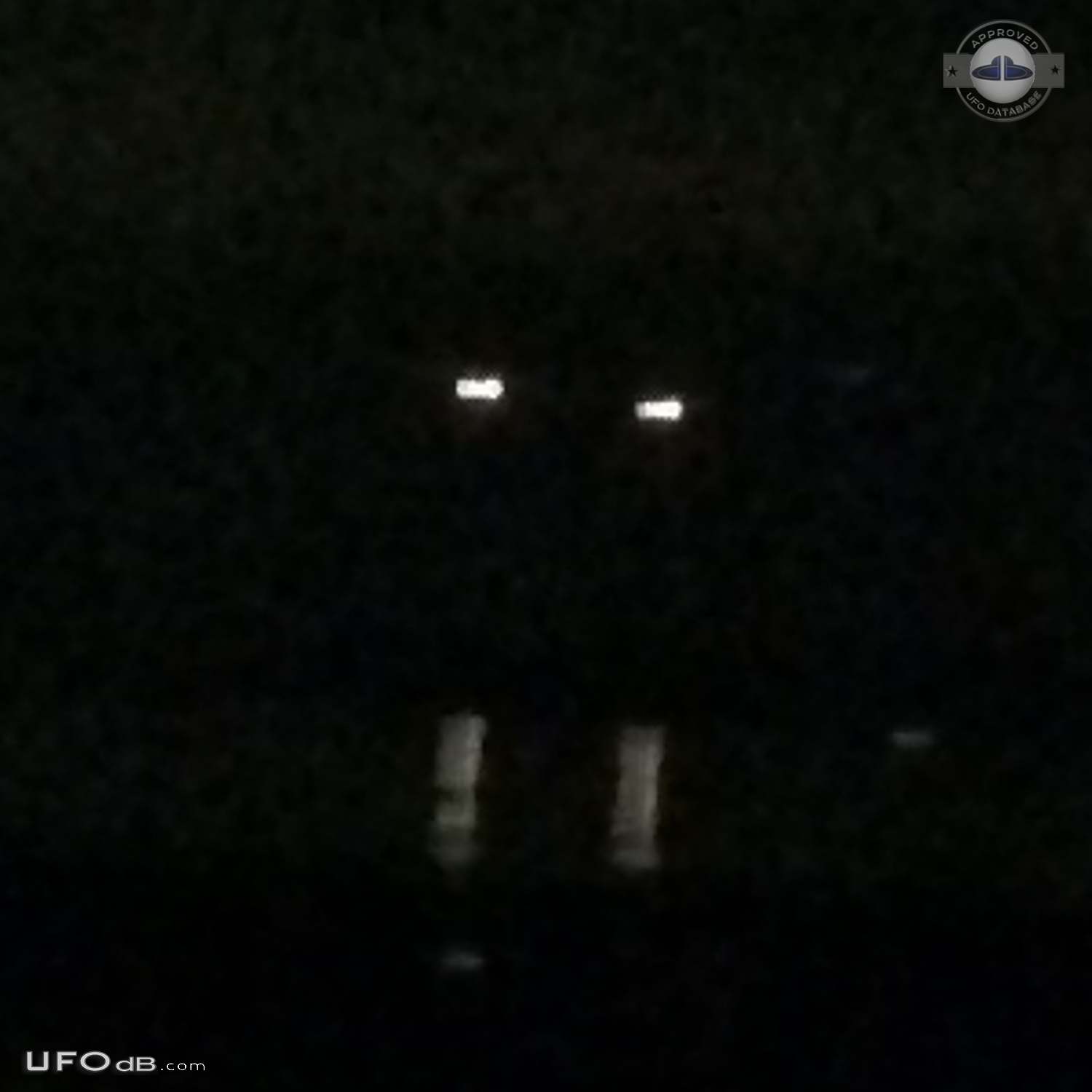 Yellowish-white UFOs with hints of red at center hovered - Clinton Was UFO Picture #755-2