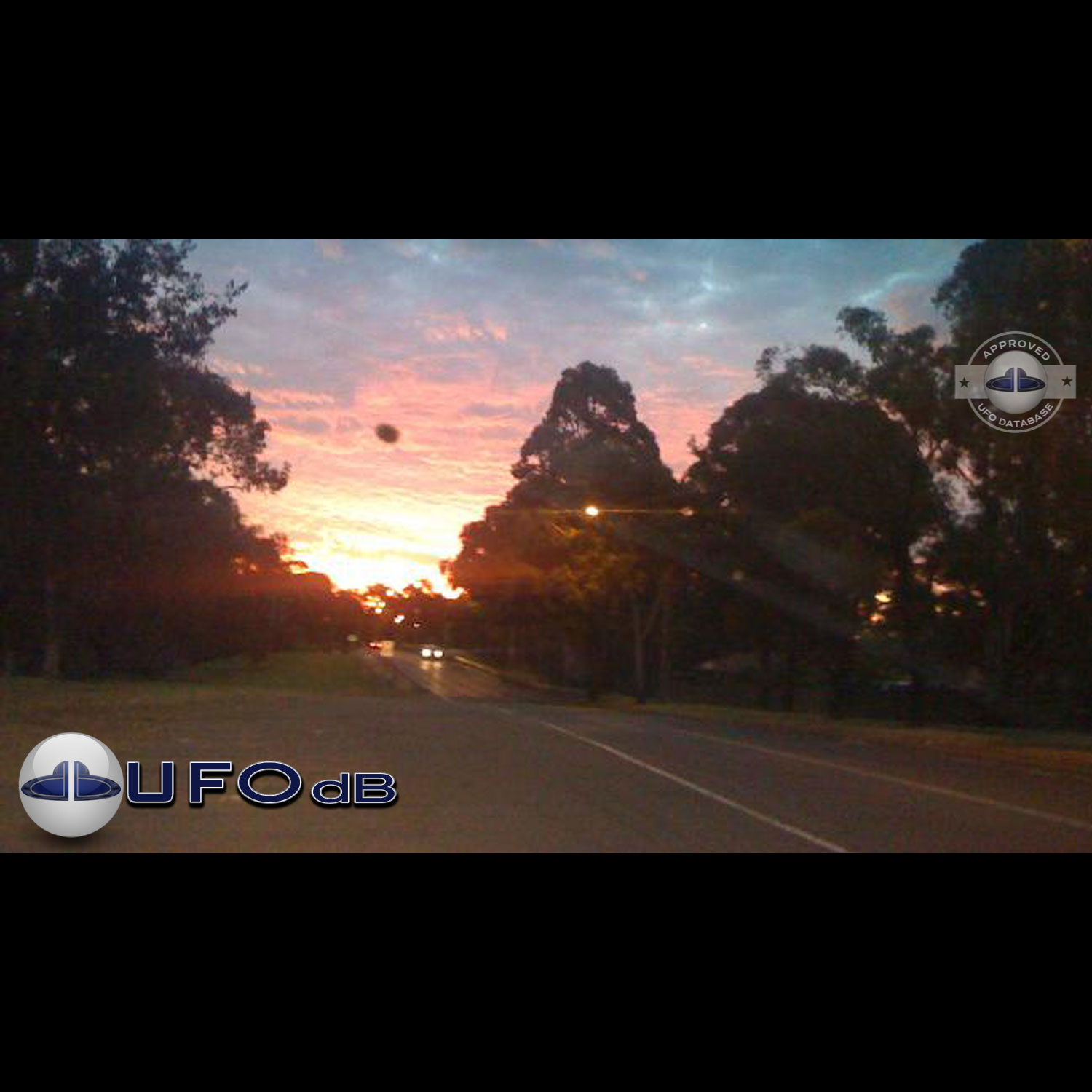 The UFO came out from a light in the cloudy sky during sunset UFO Picture #76-1