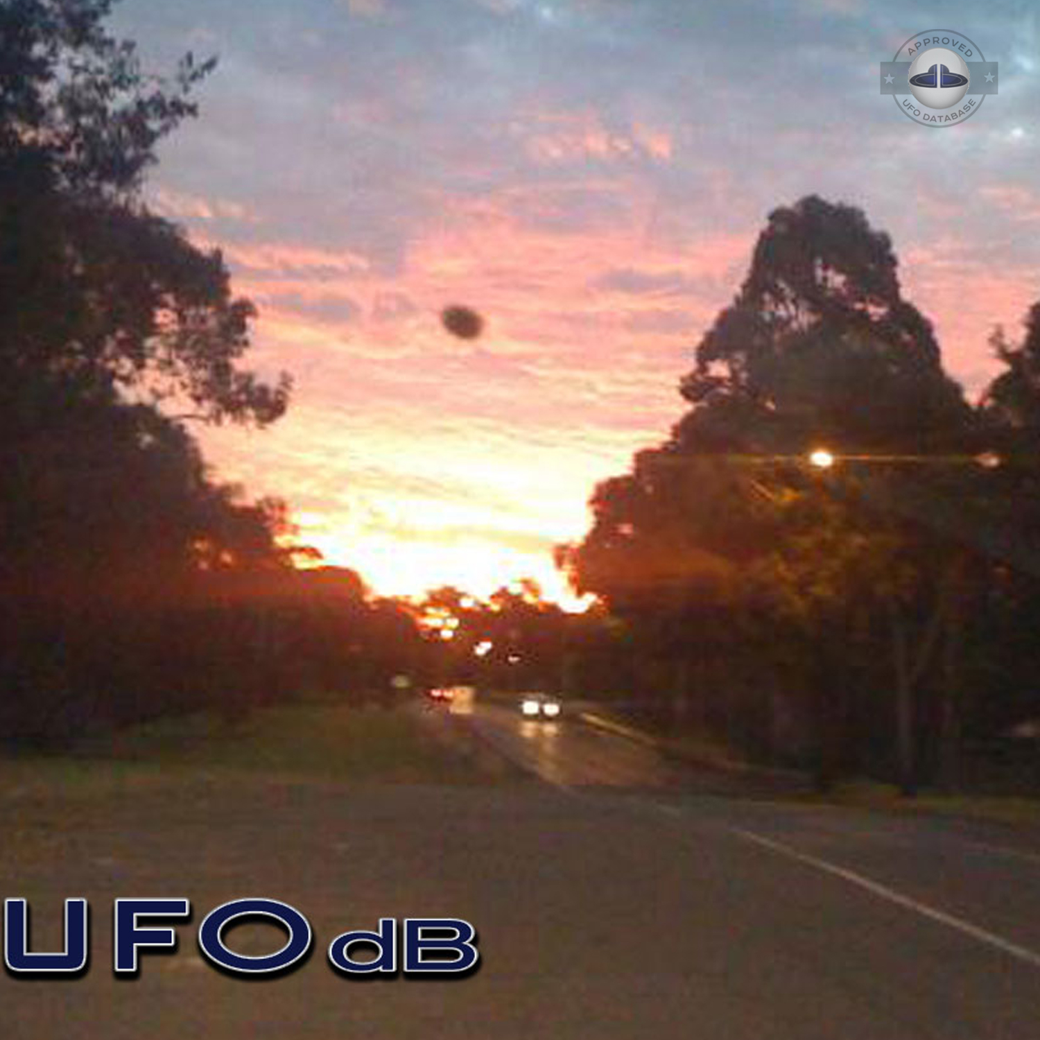 The UFO came out from a light in the cloudy sky during sunset UFO Picture #76-2