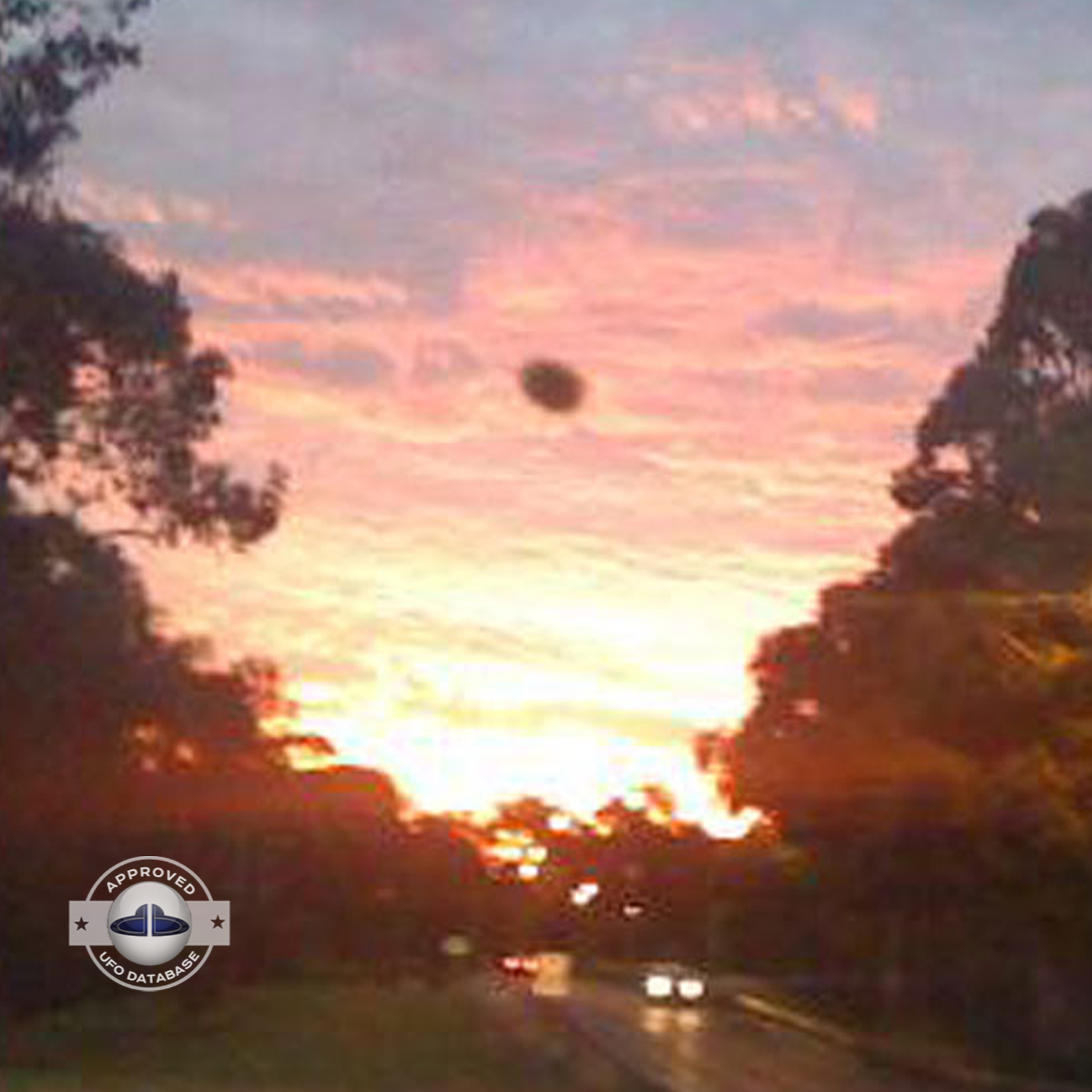 The UFO came out from a light in the cloudy sky during sunset UFO Picture #76-3