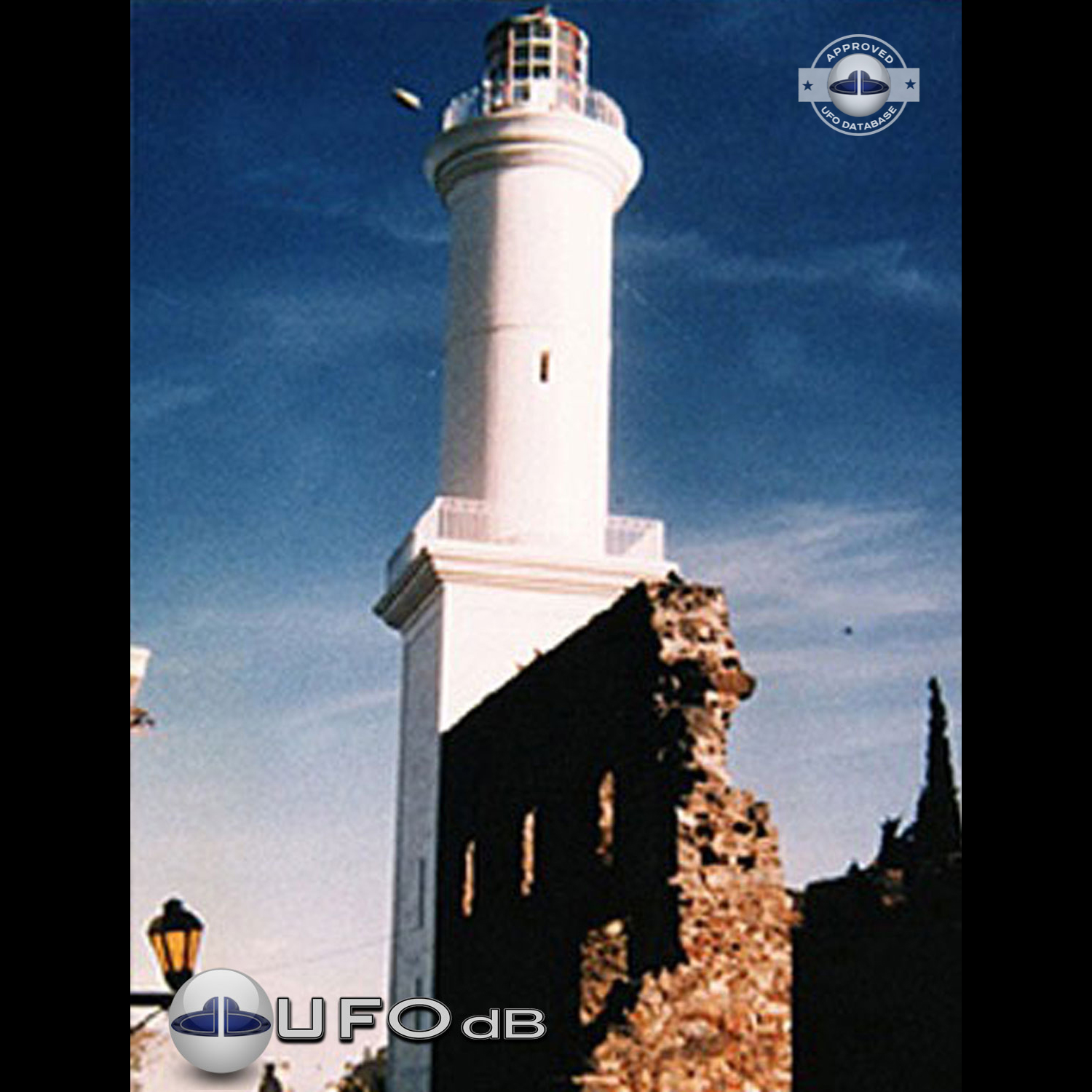 The first ufo can be seen clearly as it passed near old lighthouse UFO Picture #79-1