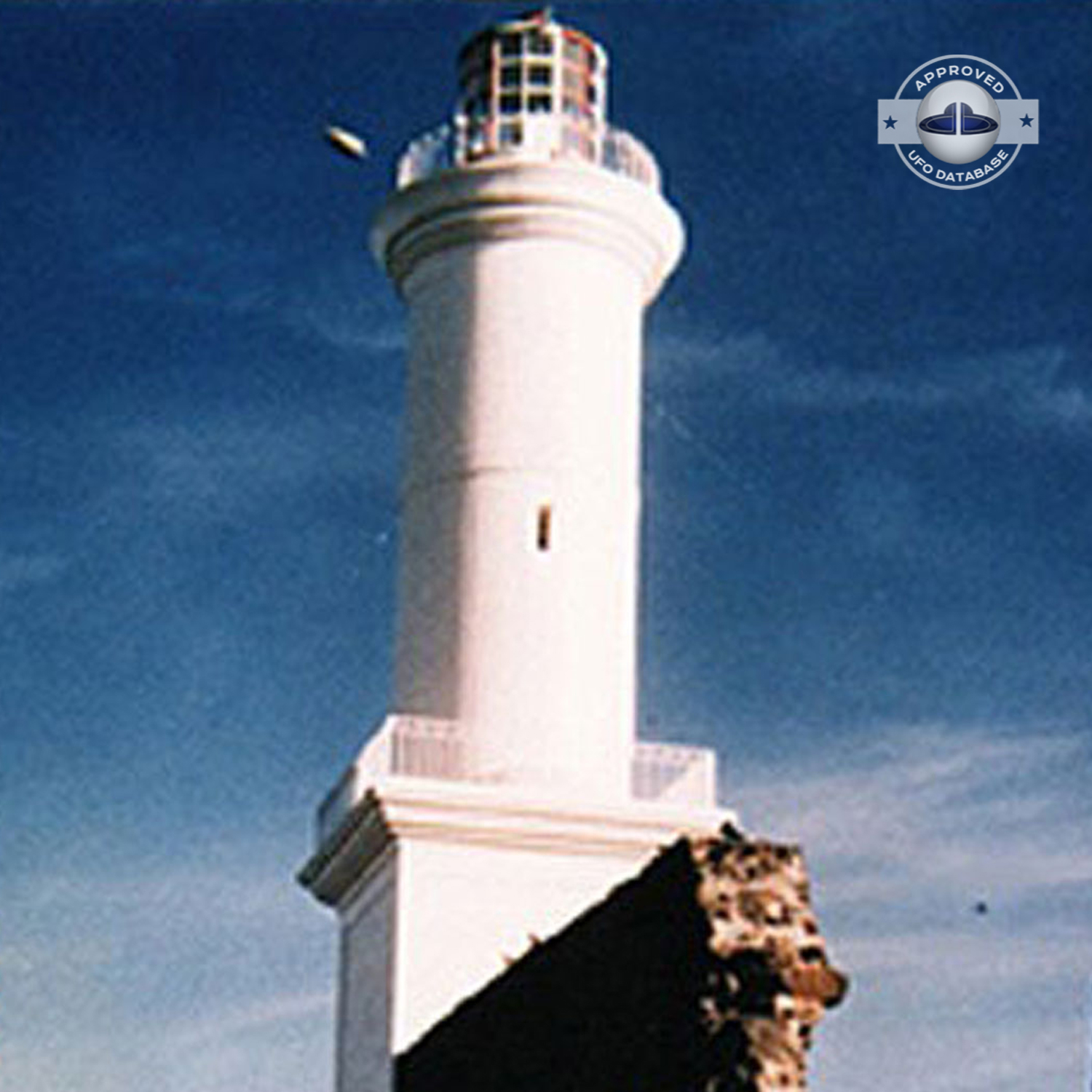 The first ufo can be seen clearly as it passed near old lighthouse UFO Picture #79-2