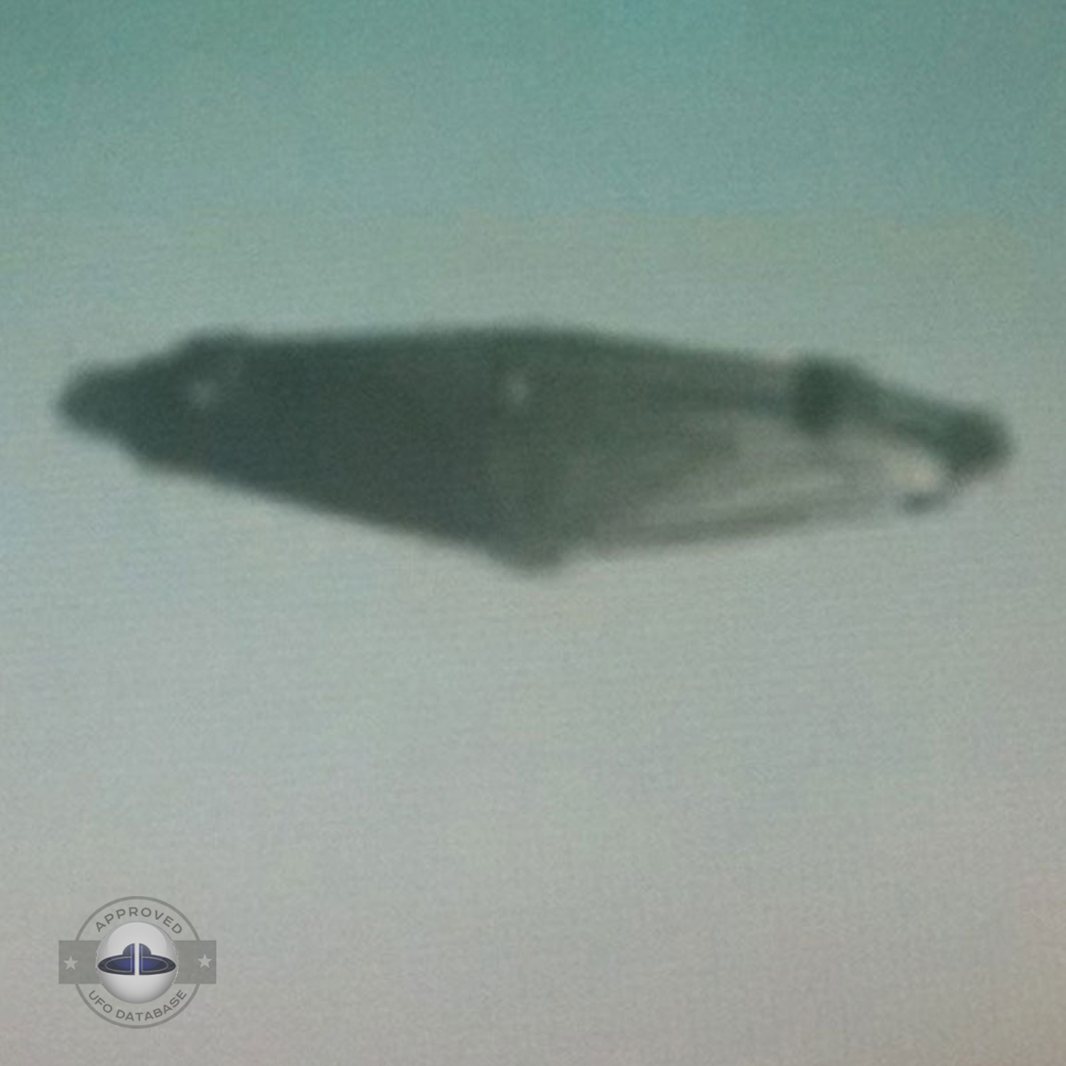 Students saw in amazement the UFO with a metallic flying saucer shape UFO Picture #90-3