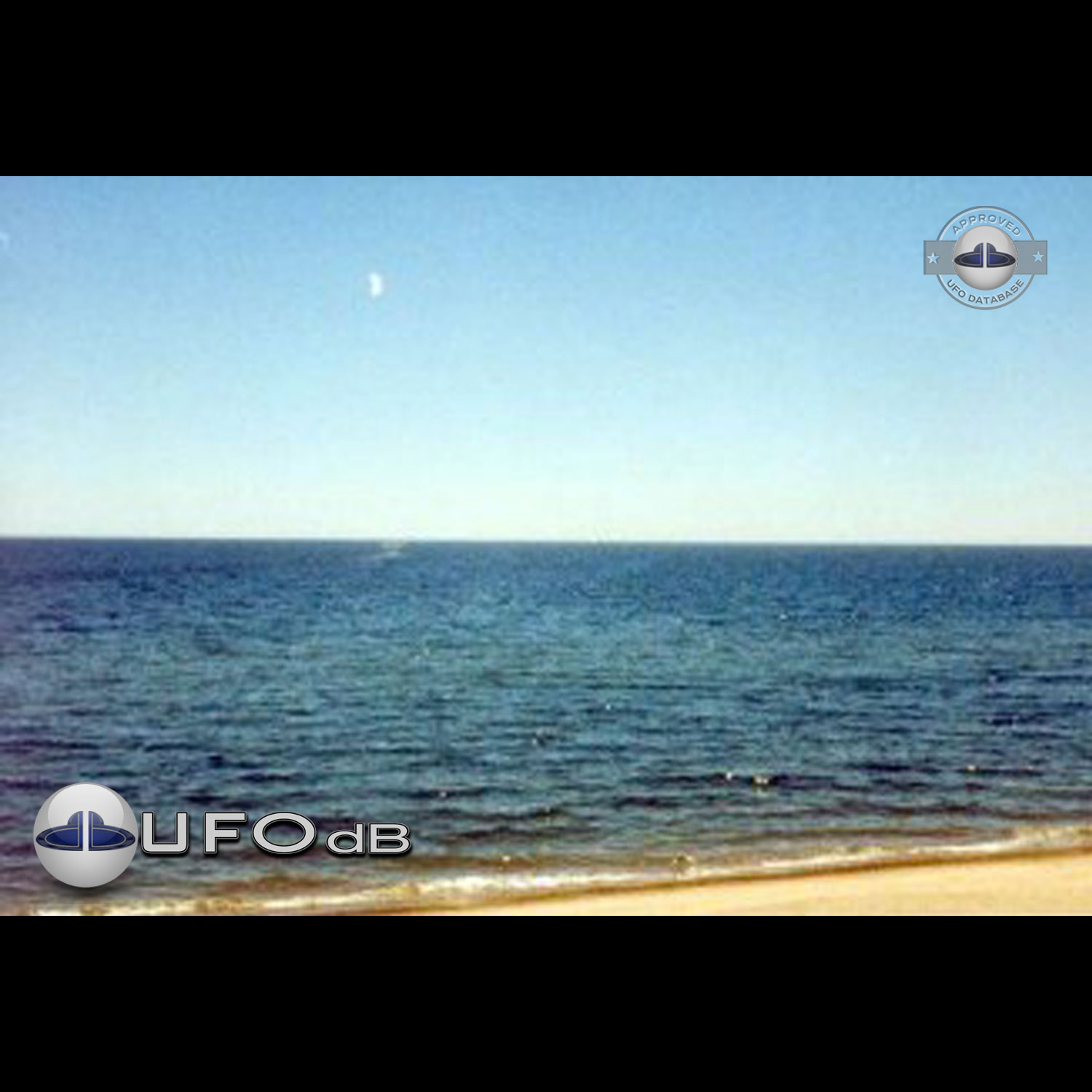 UFO flying over dark blue water near the shore of Lake Michigan USA UFO Picture #97-1