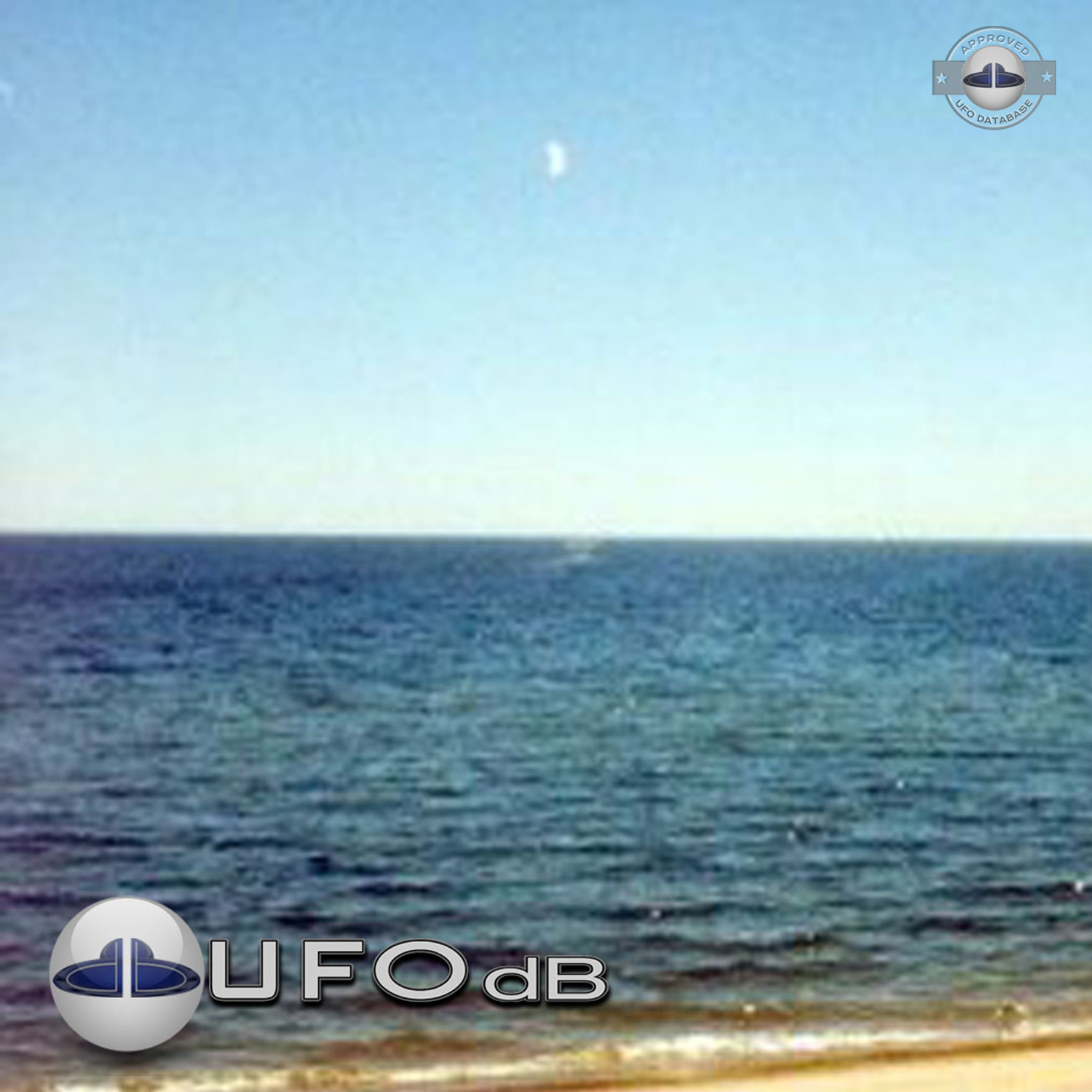 UFO flying over dark blue water near the shore of Lake Michigan USA UFO Picture #97-2