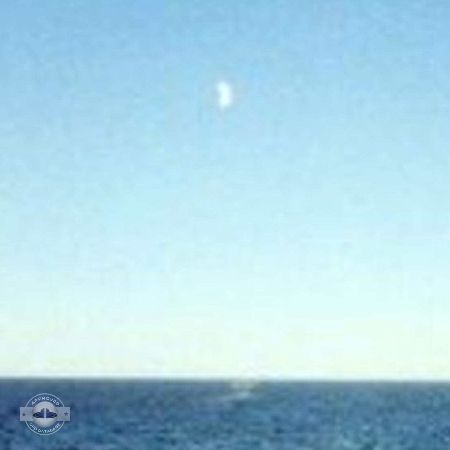UFO flying over dark blue water near the shore of Lake Michigan USA UFO Picture #97-3