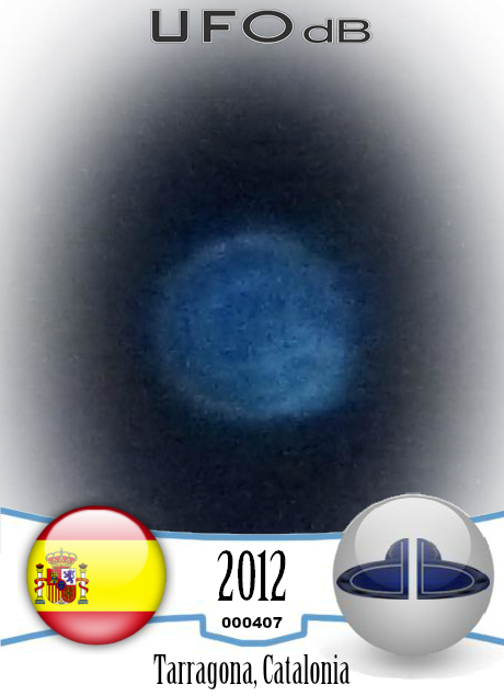 Blue round UFO appears on photo over buildings - Catalonia, Spain 2012 UFO CARD Number 407