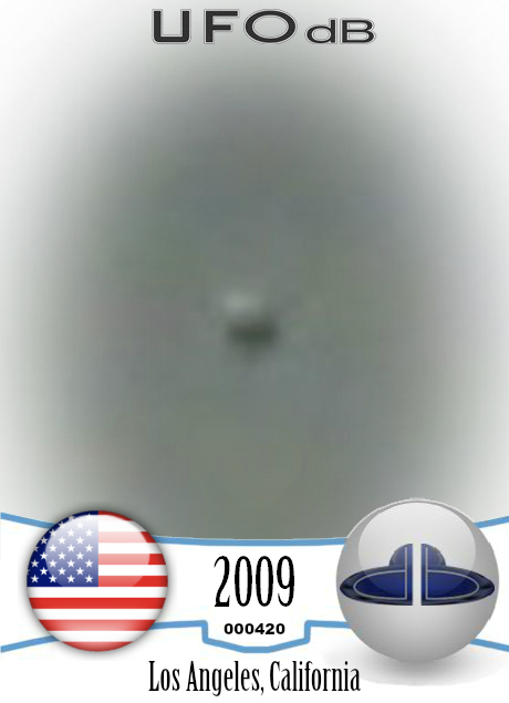 Dark UFO sphere caught on picture during storm in Los Angeles in 2009 UFO CARD Number 420