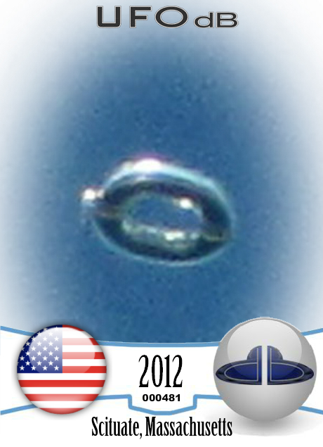Donut shaped UFO with glowing silver material over Scituate Ma US 2012 UFO CARD Number 481