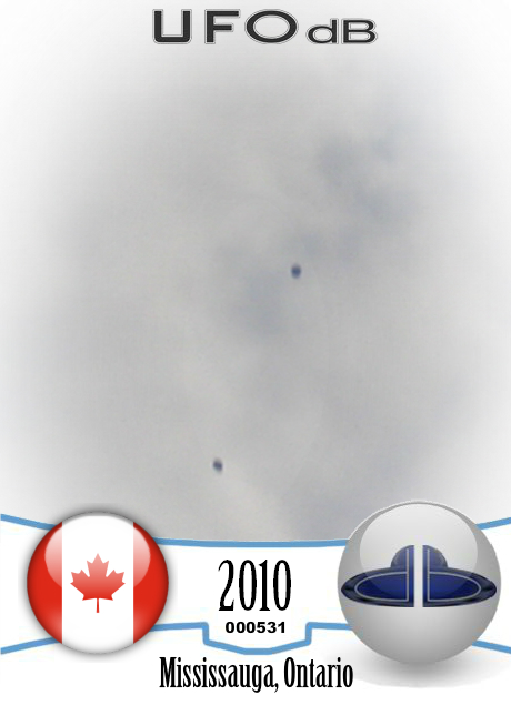 Four grey black disc UFOs near the airplane Mississauga, Ontario 2010 UFO CARD Number 531