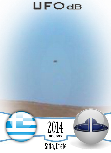 Grey saucer UFO caught on picture over Sitia, Crete Greece in 2014 UFO CARD Number 697