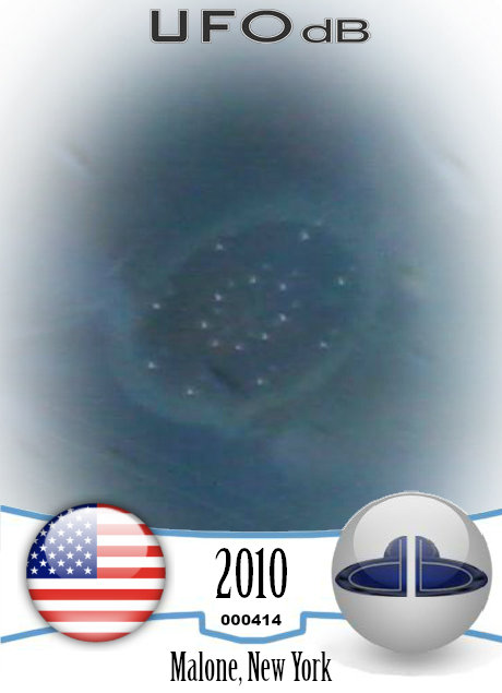 Large saucer ufo appears through dark stormy clouds - Malone, New York UFO CARD Number 414