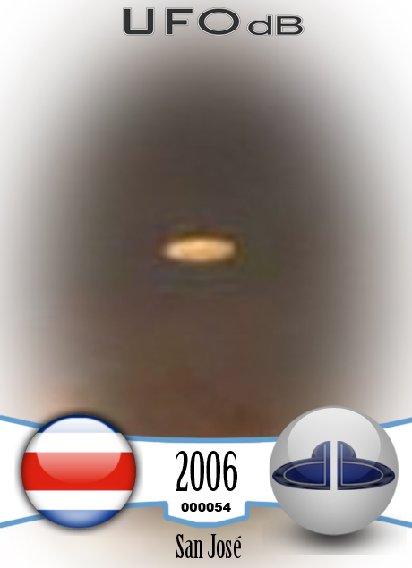 UFO picture showing a bright flat round disc passing near a building UFO CARD Number 54