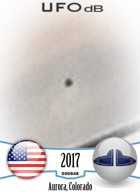 Stationary black orb observed while stuck in traffic in Aurora Colorad UFO CARD Number 848
