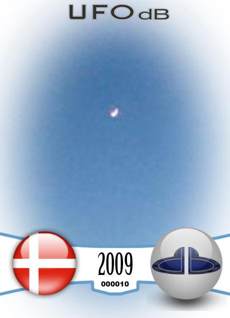 UFO picture of a UFO over a city at night fall in Denmark UFO CARD Number 10